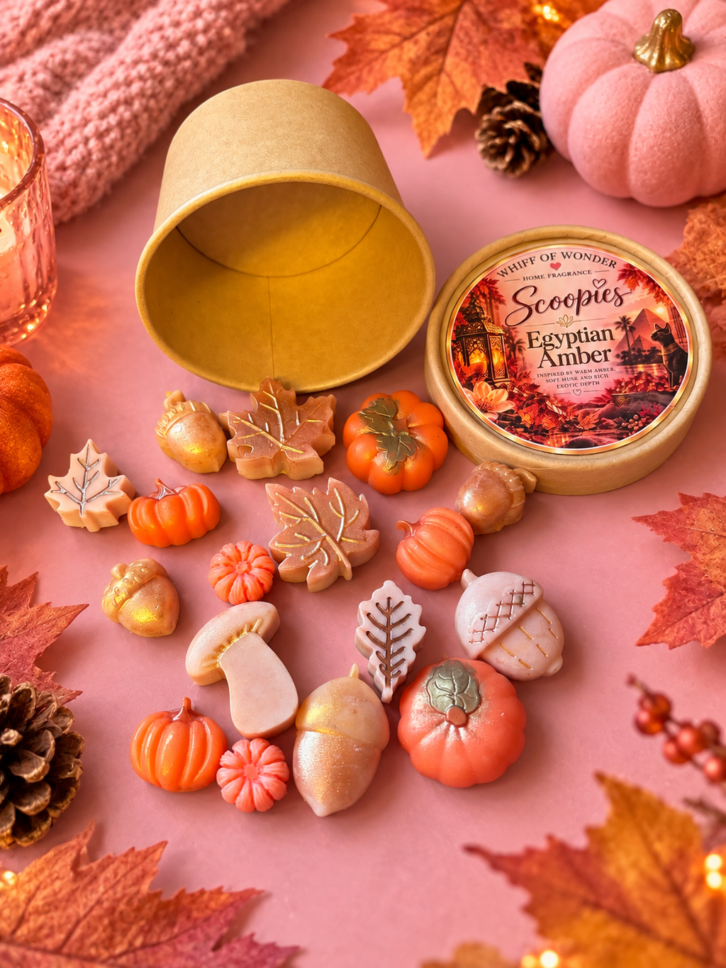 Egyptian Amber scoopie wax melts shaped like pumpkins and leaves spilling from a kraft tub.