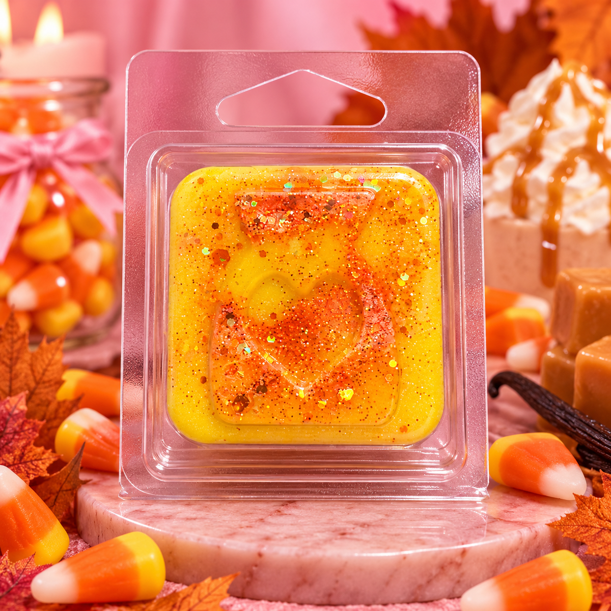 Yellow and orange Candy Corn sample wax melt with a heart design, surrounded by candy corn sweets.
