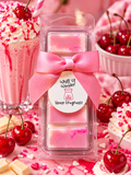 Pink and cream Cherry Milkshake waxident wax melt bar with a pink bow, surrounded by cherries and milkshakes.