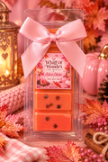 Orange Egyptian Amber wax melt bar with a pink bow and floral label, surrounded by autumn decorations.