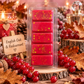 Red English Oak & Redcurrant wax melt bar with gold flecks, displayed among redcurrants and autumn leaves.